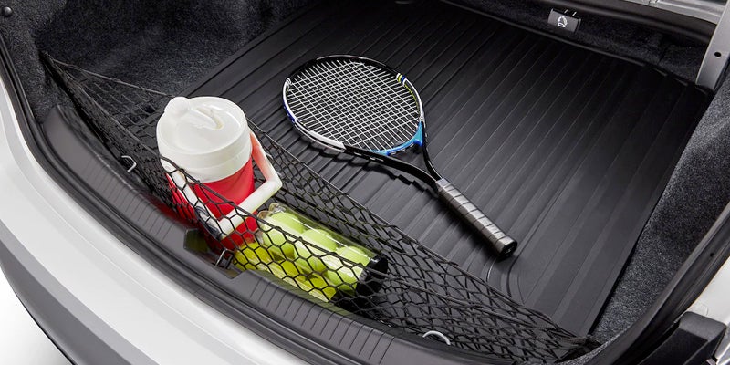 tennis ball and racket in trunk of Chevy Malibu