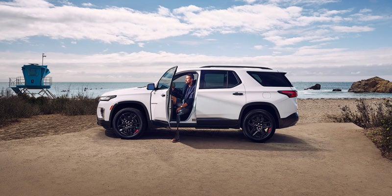 man coming out of white Chevy Traverse