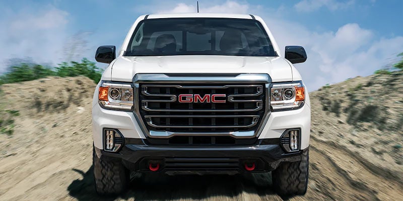 front of white GMC Canyon