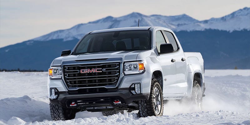 white GMC Canyon on snow