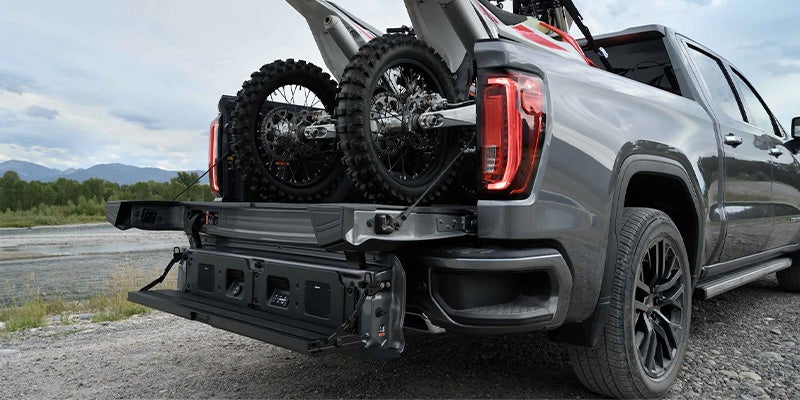 two bikes in trunkof GMC Sierra 1500 LTD